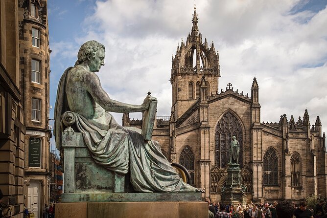 Edinburgh Castle & Royal Mile Walking Tour - Ticket Included - Starting beneath the blue umbrella on the Royal Mile